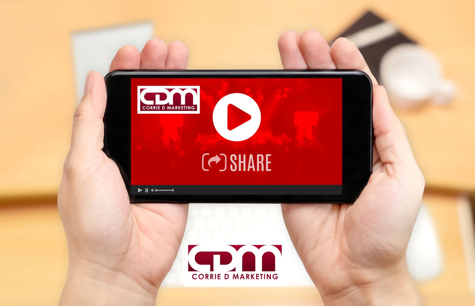 Hands holding a smartphone playing a Corrie D Marketing branded video with a share button