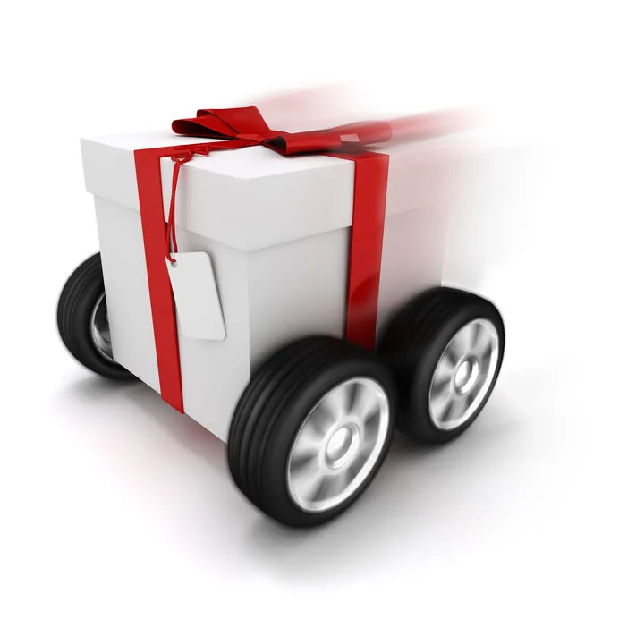 Anniversary offer — a wrapped gift with a red ribbon racing along on wheels