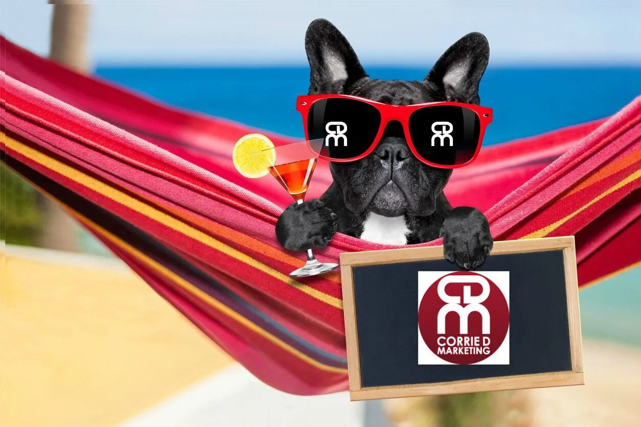 French bulldog in red sunglasses relaxing in a red hammock with a cocktail, holding a Corrie D Marketing sign
